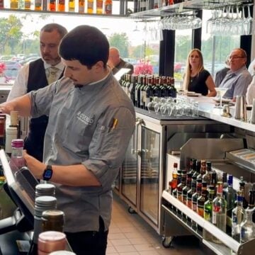 Bartender preparing drinks behind the bar at Rosebud Steakhouse in St. Charles