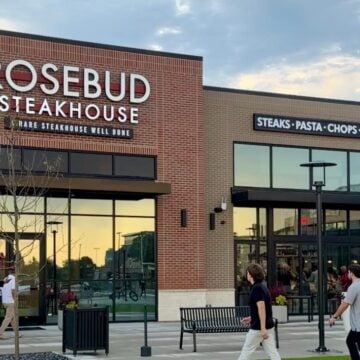 Brick exterior of Rosebud Steakhouse in St. Charles with its sign and lawn in front